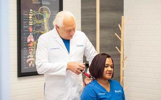 Gorm Laursen performing a treatment on Candace Holmes