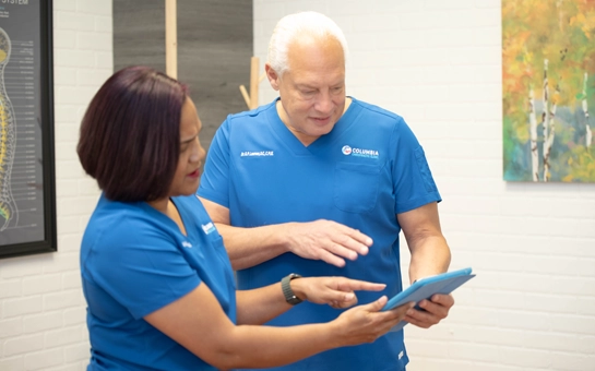 Candace Holmes and Gorm Laursen reviewing paperwork.