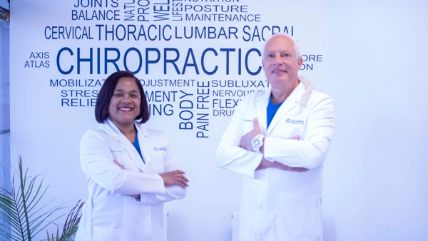 Candace Holmes And Gorm Laursen Smiling in white coats.