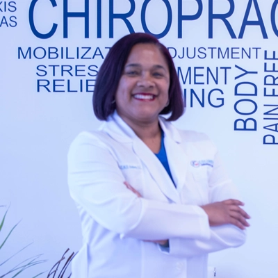 Candace Holmes smiling in a white coat.